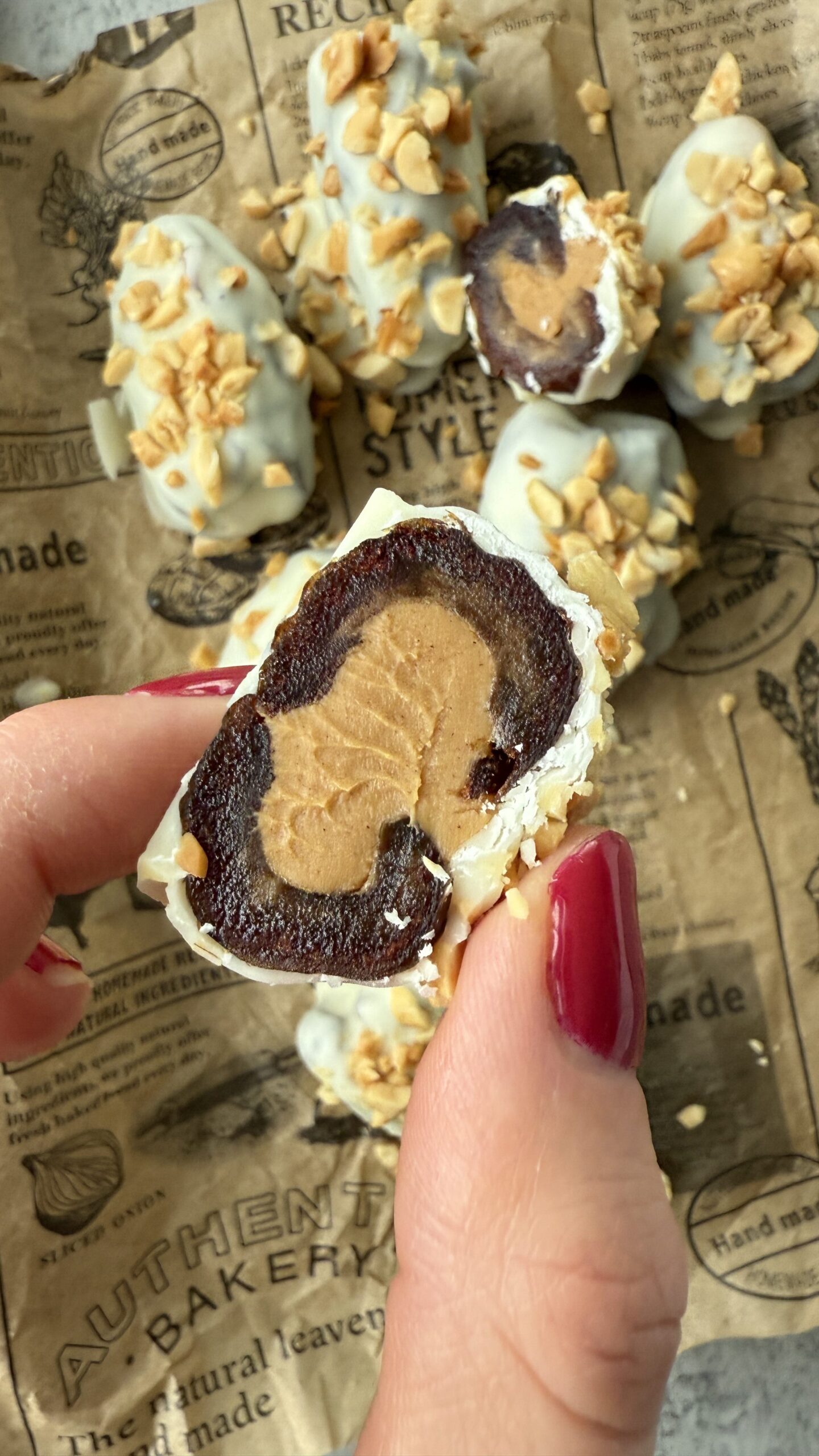 white chocolate covered peanut butter date cut open to show peanut butter in center - easy no bake desserts