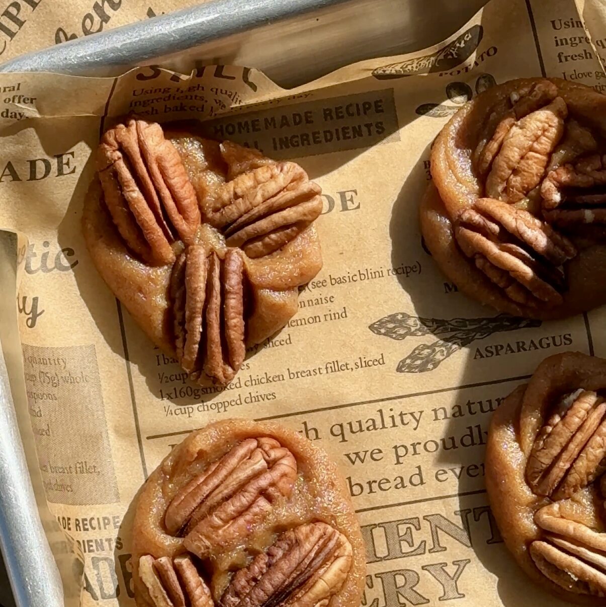 pecan turtles on baking sheet in date caramel
