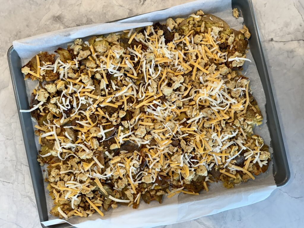 Assembling Cheeseburger Sheet Pan Nachos with ground turkey